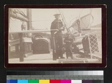 Ship crewman and small boy on unidentified ship, both in sailor outfits