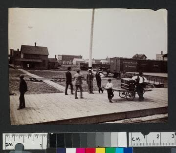People standing at a train depot in unidentified location