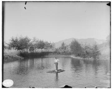 An unknown man on a raft at an unknown location