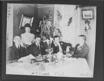 A dinner at the superintendent's house at Mill Creek #1 Hydro Plant.  Men seated (l-