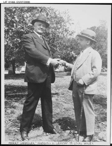 Harry Chandler "handing a lemon" to Louis Wiley