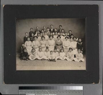 Chin Quan Gue and Mabel Chin in a group photograph