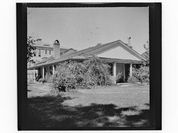 Unidentified house next to three-story building