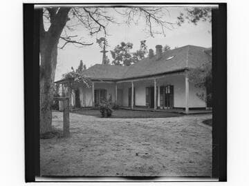 Unidentified house with windmill in background