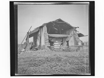 Remains of a two-story adobe building in a field