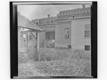 Unidentified brick house with decorative Mansard roof