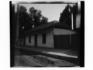 Adobe building with wooden shutters