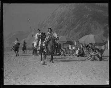 Women playing polo on the beach in Santa Monica