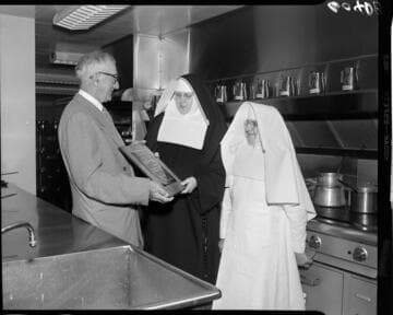 Saint Francis Hospital nuns receiving Merit Award from Institutions Magazine in hospital kitchen