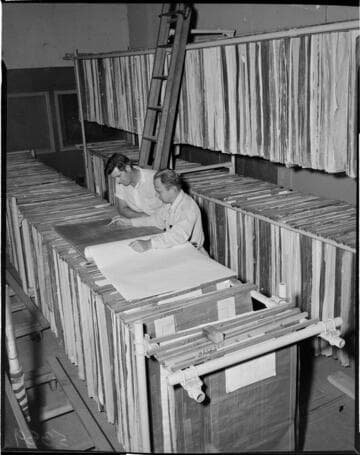 Men looking at plans in drawing file area