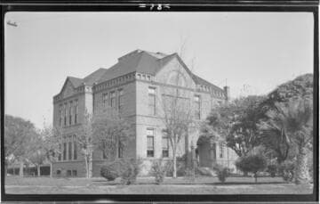 Street view of a Visalia high school surrounded by trees