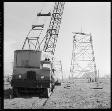 Transmission tower construction using a crane