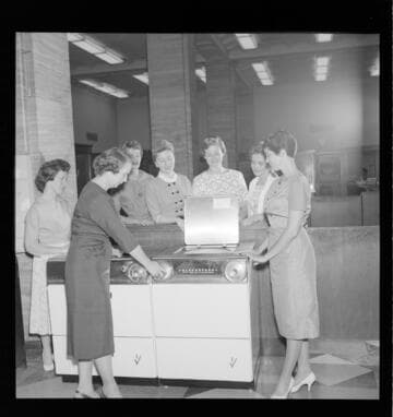 Four women around a GE electric range on display
