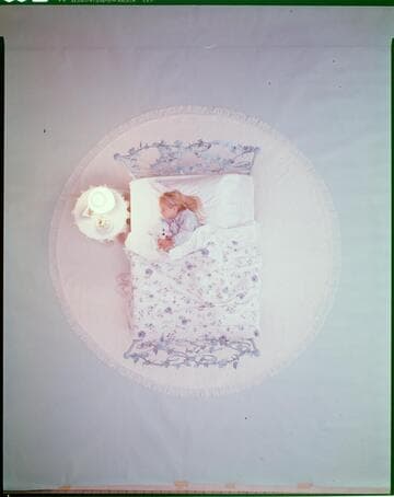 Family at home with little girl sleeping with her teddy bear