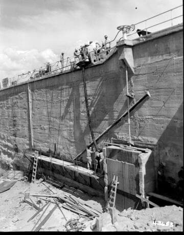 Big Creek, Huntington Lake Dams - Placing concrete in back of steel sheets in section adjacent to 72" sluice gate