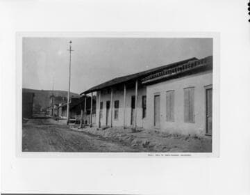 This 1887 view of East De La Guerra Street shows the old Antonio Arrellanes adobe and an arc-light on a high wooden pole