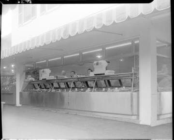 Fish monger's counter with fish displayed on ice in refrigerated cases (unknown Oyster Bar)