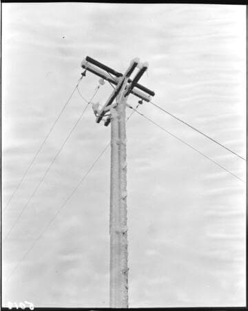 Shot looking up ice covered corner pole