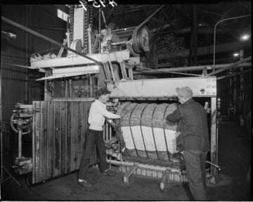 Men working with cotton baler
