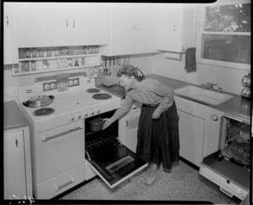 Woman placing food  in oven