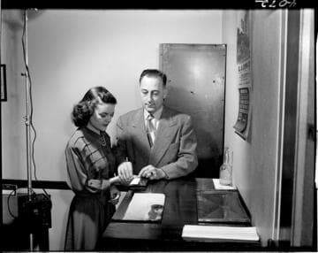 Young lady (new employee?) being finger printed