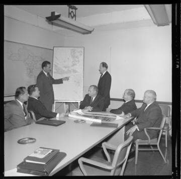Men reviewing plans at a meeting