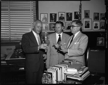 Executives in office with antique light bulbs