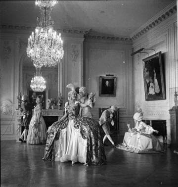 Three couples in period costume in the large drawing room in the Huntington residence
