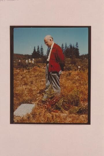 Marston reads the inscription on Buzz Holmstrom's grave; Coquille, Oregon
