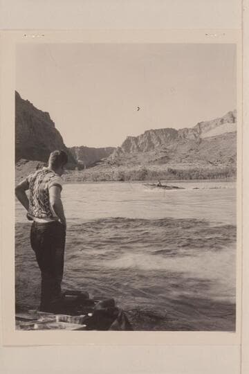 Edward Hudson watches the "Esmeralda" [II] with Ed Hudson at the controls immediately after it was put in the River at Lees Ferry.  The boat is carrying no load but is under full power from the 75HP Gray motor