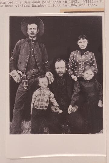 Family of Jonathan Paul Williams.  William Franklyn Williams is standing.  Jonathan P. Williams is reported to have been the one who started the San Juan gold boom in 1892.  William F. claims to have visited Rainbow Bridge in 1884 and 1885