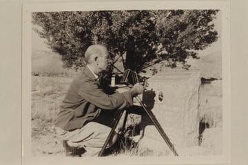 The gathering of river data.  Photographing the photograph of Seymour Dubendorff on the headstone of his grave at Myton, Utah