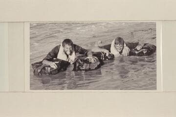 Daggett and Beer demonstrating their water wings with which they traversed the Grand Canyon in 1955, Apr.-May.  Lower end of Grand Canyon about 2 miles above Emory Falls