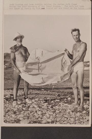 Dock Marston and Norm Nevills holding the rubber raft found during the 1948 traverse of the Grand Canyon
